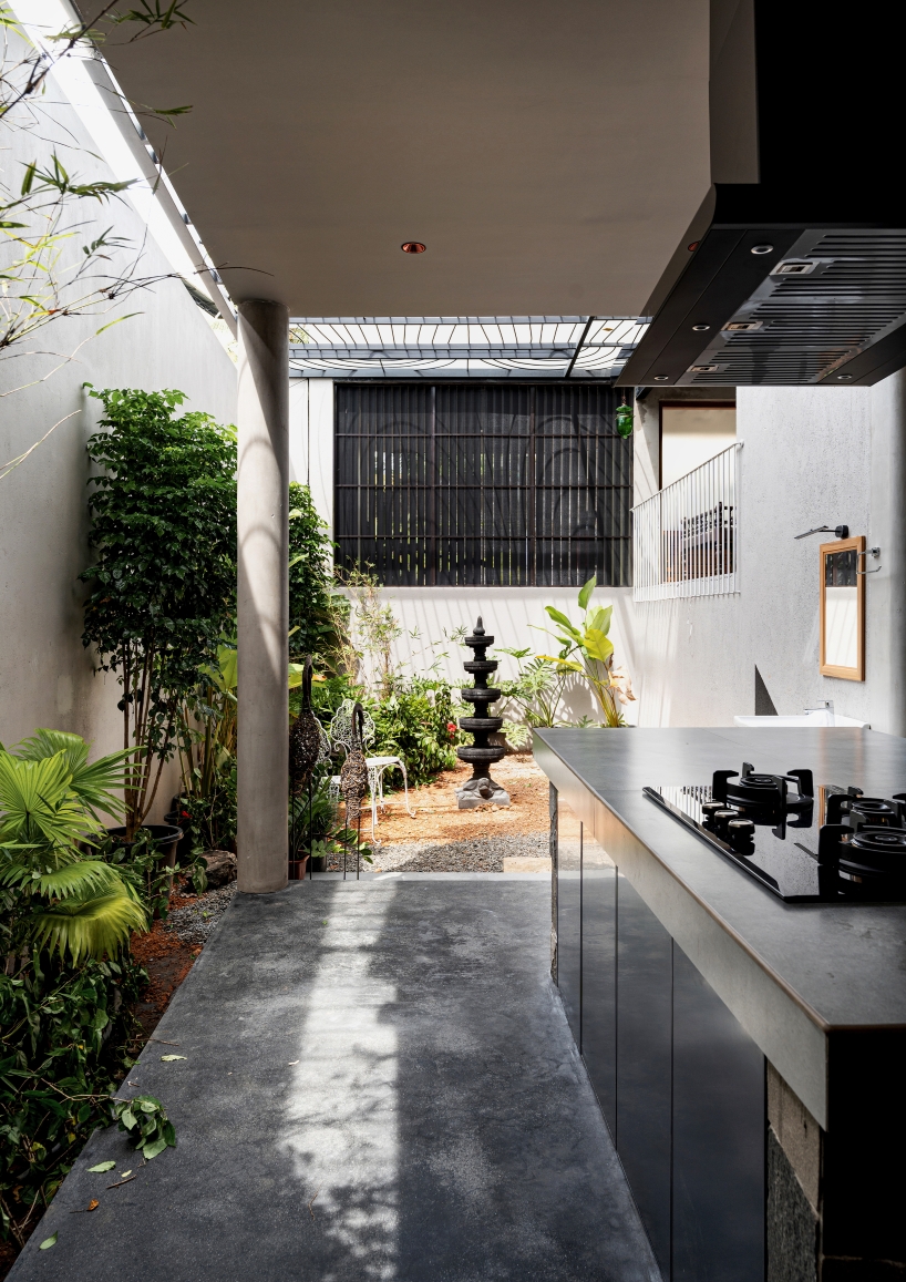 circular green terraces carve through exposed concrete facade in india