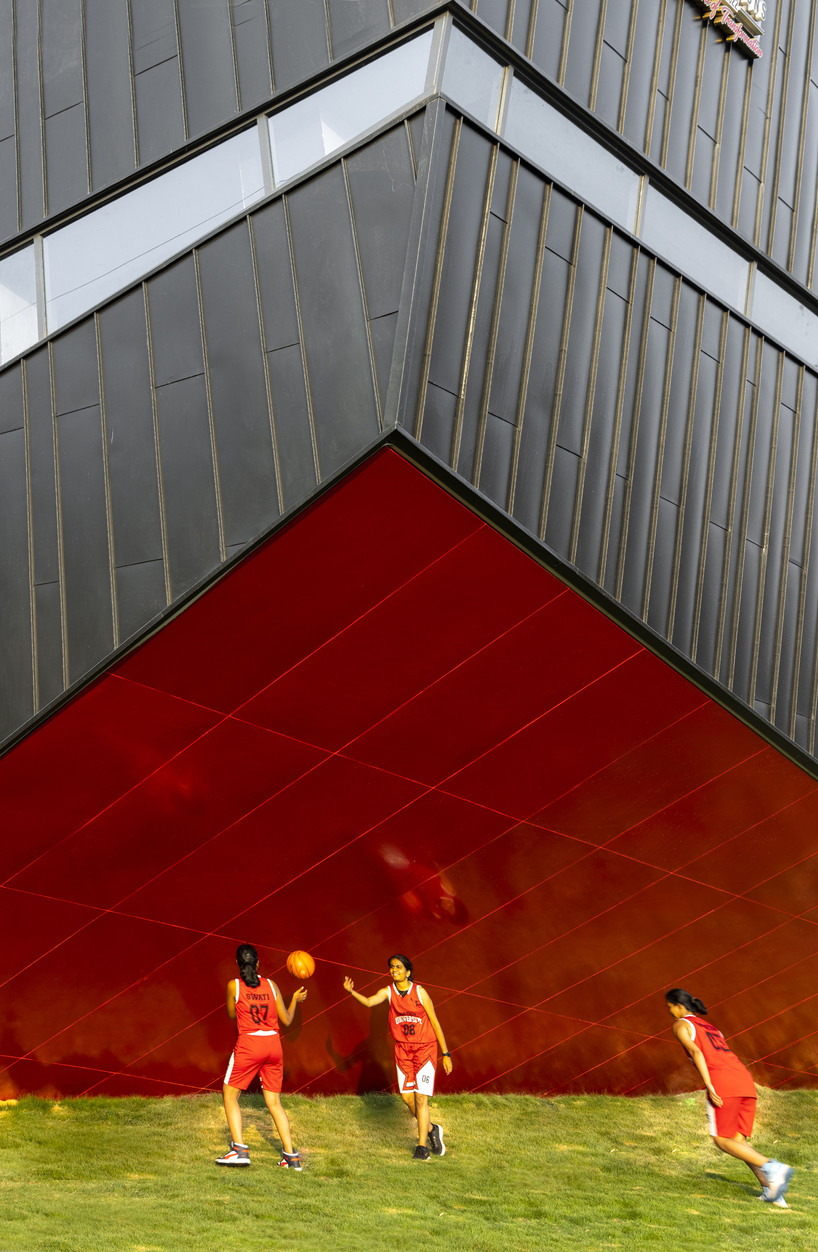 pyramidal steel roof by thirdspace tops university's sports arena in india