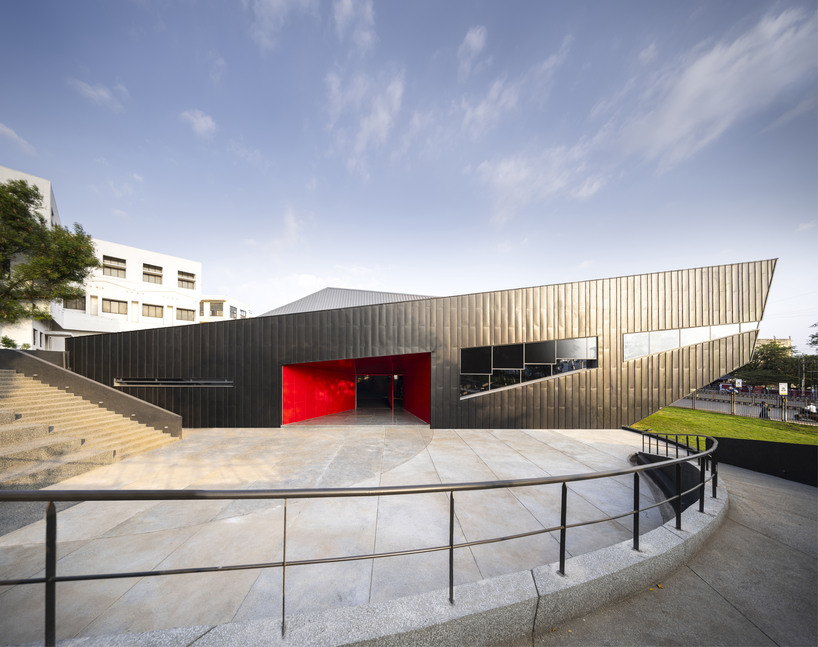 pyramidal steel roof by thirdspace tops university's sports arena in india