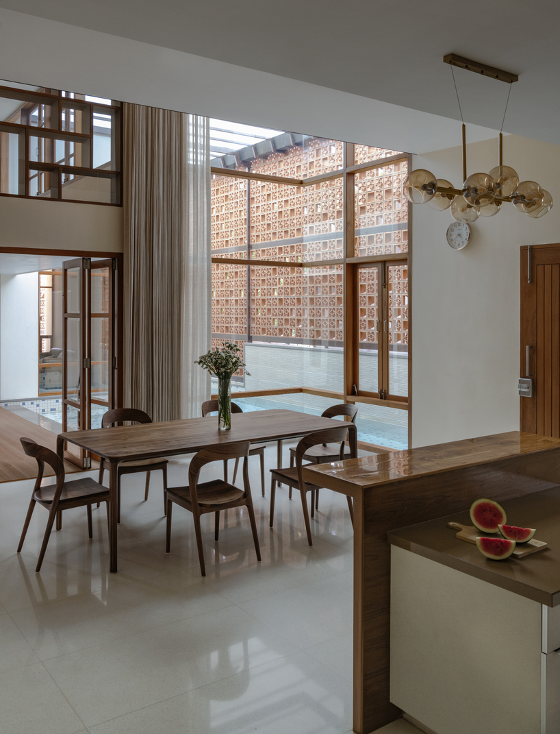 perforated terracotta screens enclose pool pavilion within indian residence