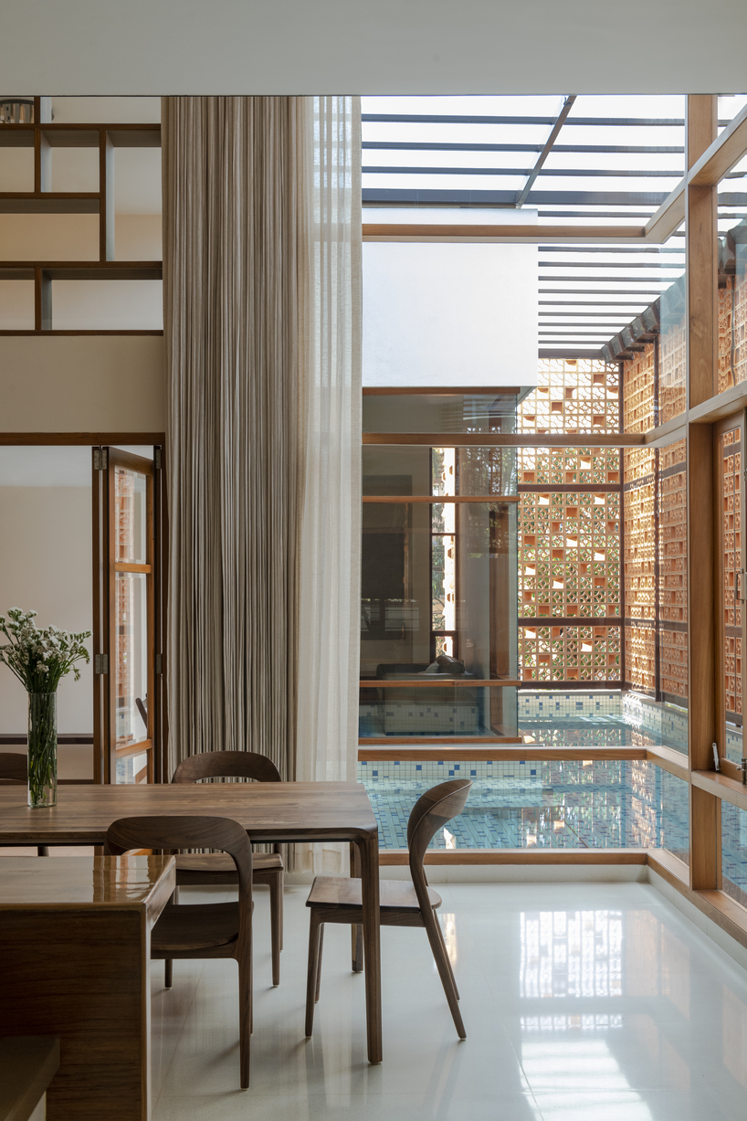 perforated terracotta screens enclose pool pavilion within indian residence