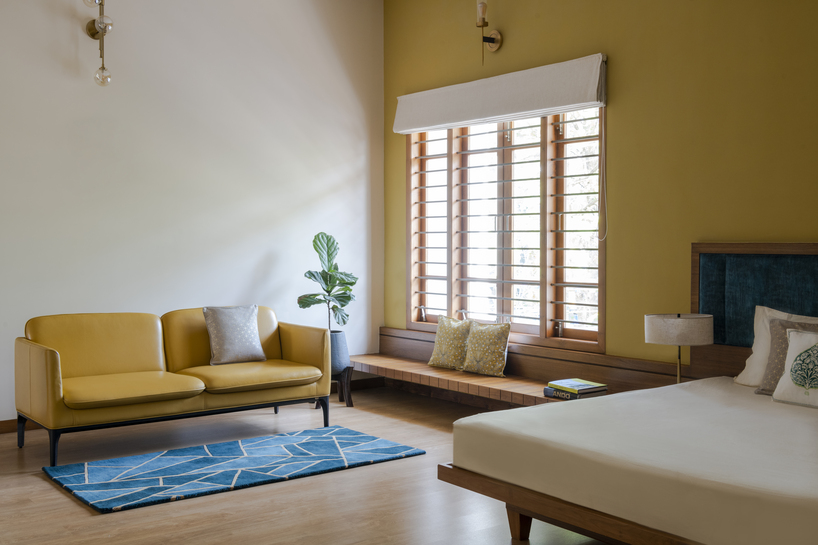 perforated terracotta screens enclose pool pavilion within indian residence