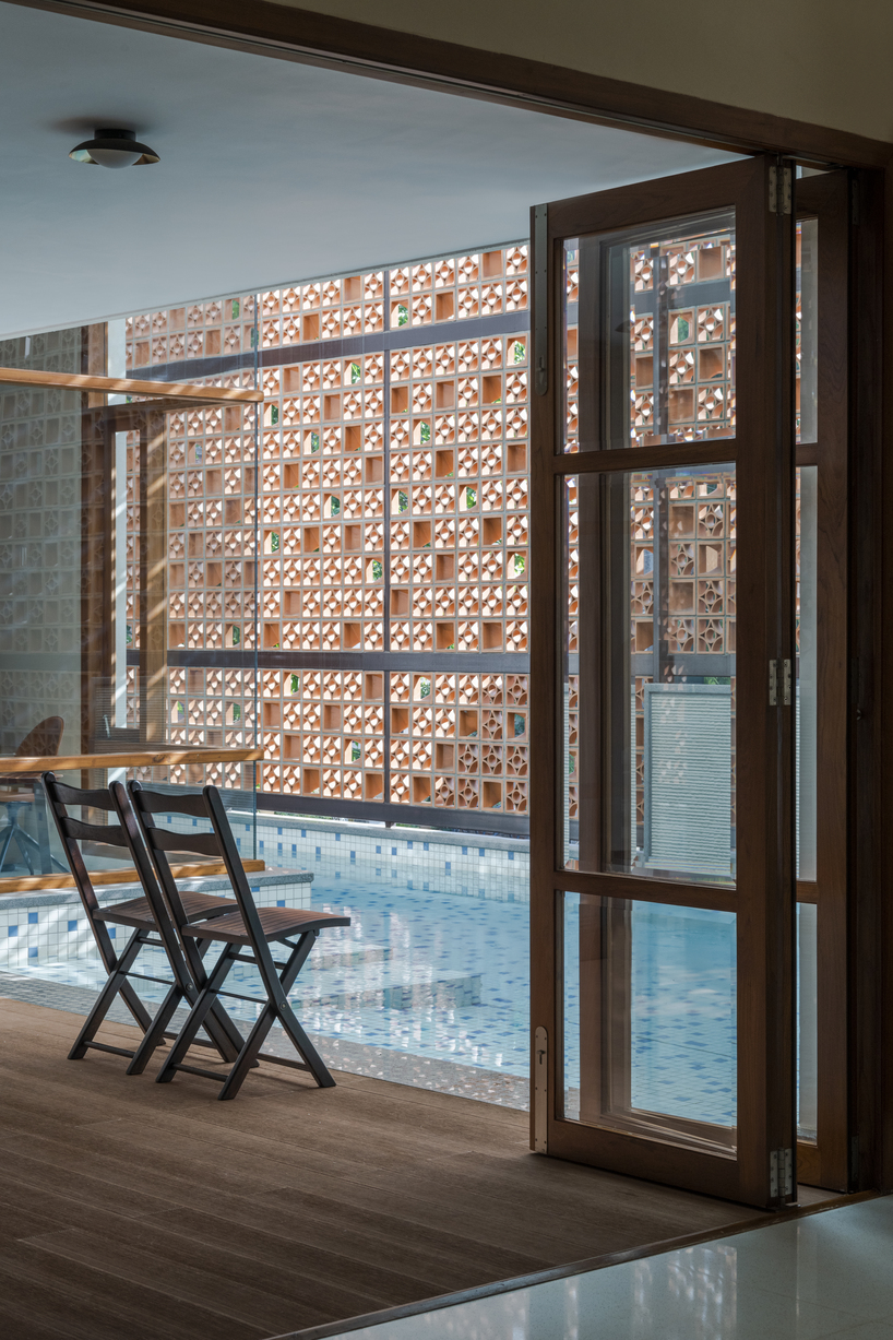 perforated terracotta screens enclose pool pavilion within indian residence