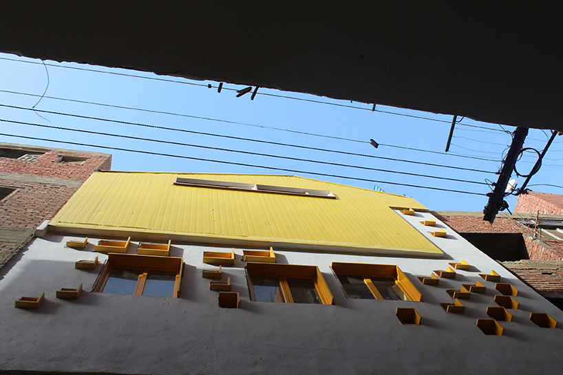 ahmed hossam saafan builds a yellow cultural center in one of cairo's most populated slums