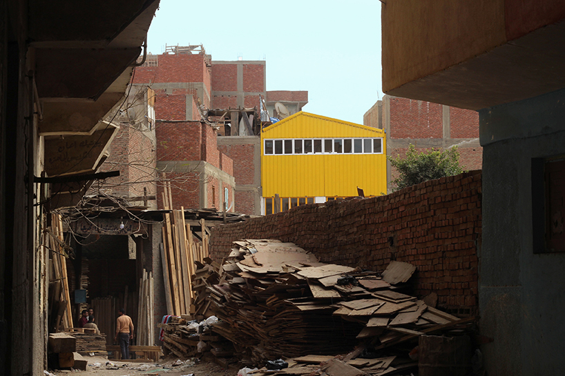 ahmed hossam saafan builds a yellow cultural center in one of cairo's most populated slums