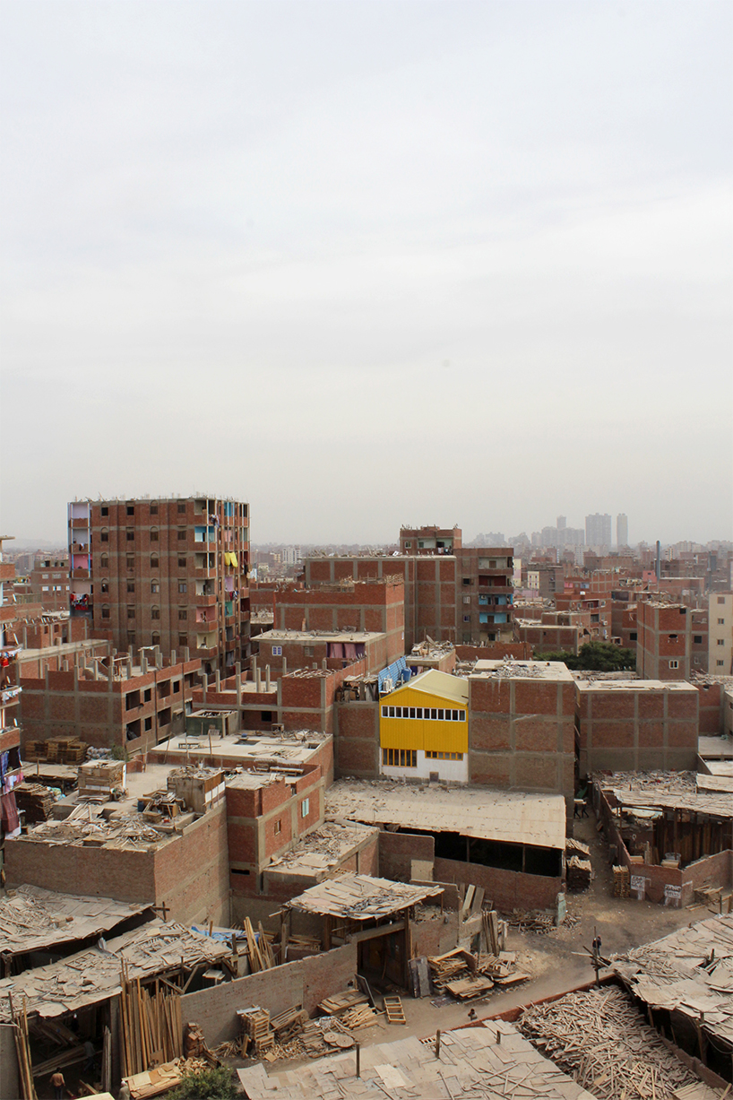 ahmed hossam saafan builds a yellow cultural center in one of cairo's most populated slums