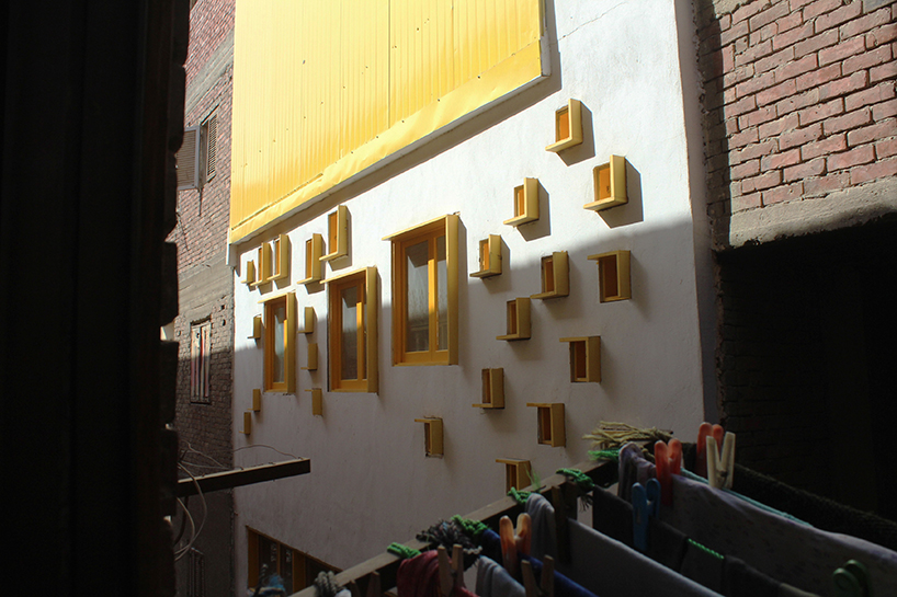 ahmed hossam saafan builds a yellow cultural center in one of cairo's most populated slums