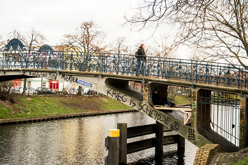 brückenbunker is an urban micro refuge tucked under a pedestrian bridge in berlin designboom