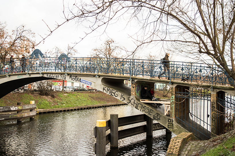 brückenbunker is an urban micro refuge tucked under a pedestrian bridge in berlin designboom