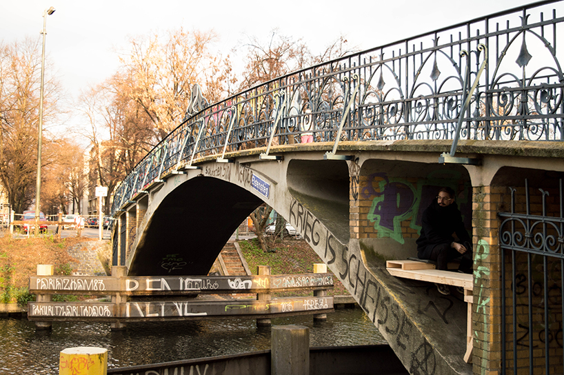 brückenbunker is an urban micro refuge tucked under a pedestrian bridge in berlin designboom