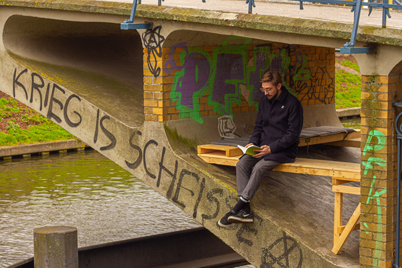 brückenbunker is an urban micro refuge tucked under a pedestrian bridge in berlin designboom