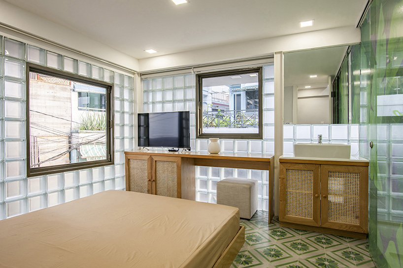 room+ design & build renovates tiny house in vietnam with glass-block façades