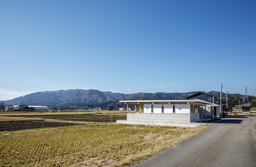 repeatable wooden grid frame supports small 'nanto house' by kazuto nishi architects in japan