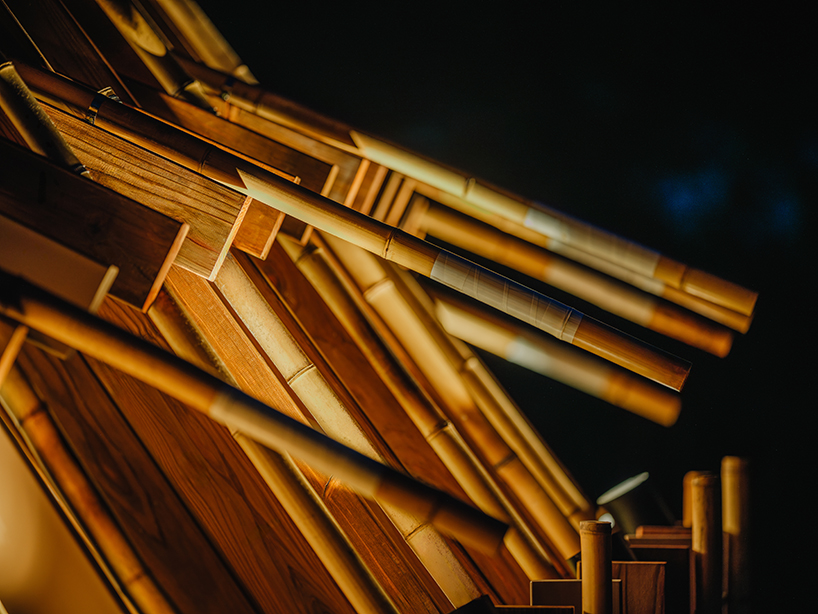 interlocking bamboo and cedar frames shape wild boar nest installation by cheng tsung feng