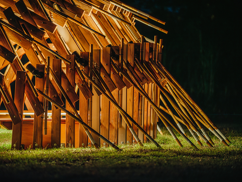 interlocking bamboo and cedar frames shape wild boar nest installation by cheng tsung feng