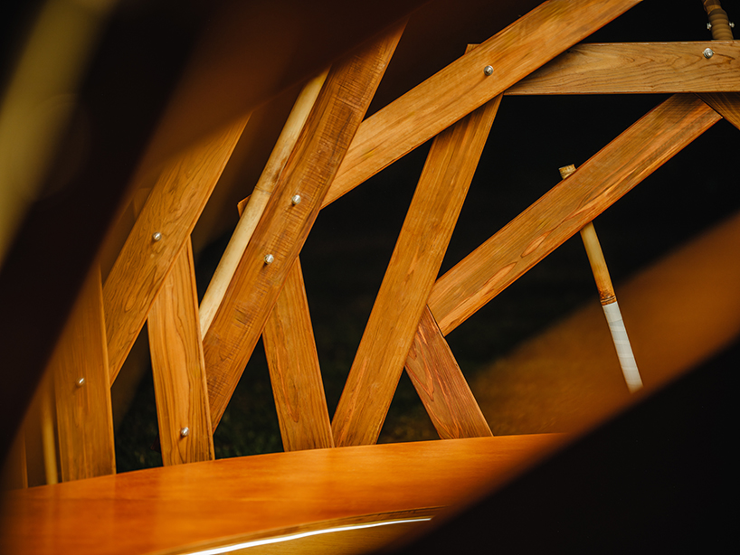 interlocking bamboo and cedar frames shape wild boar nest installation by cheng tsung feng