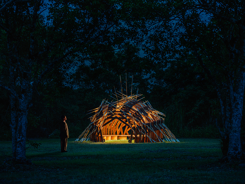 interlocking bamboo and cedar frames shape wild boar nest installation by cheng tsung feng