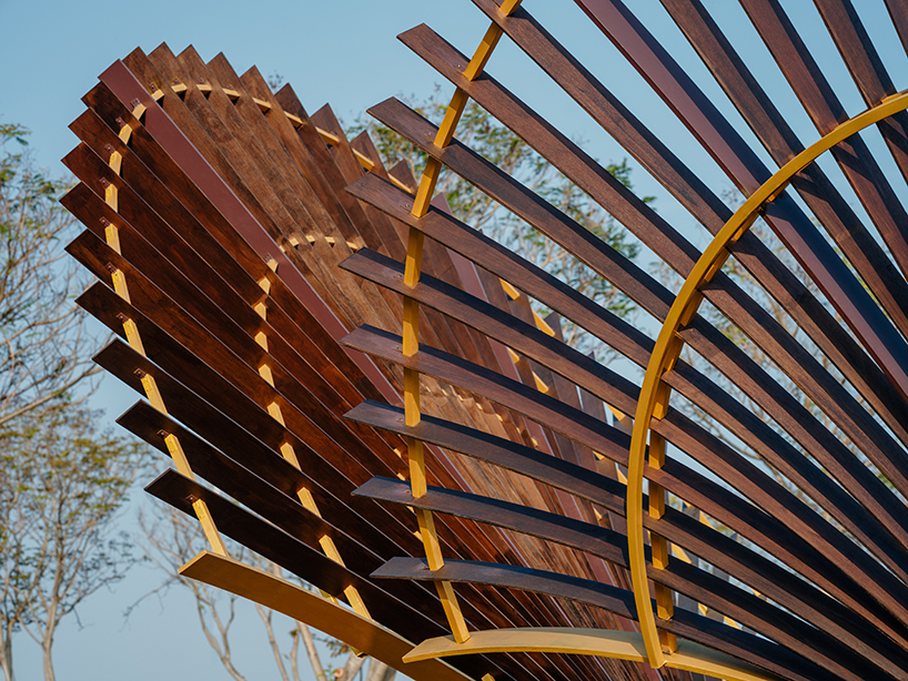 bent wooden beams fan like illuminating petals in cheng tsung feng&rsquo;s installation in taiwan