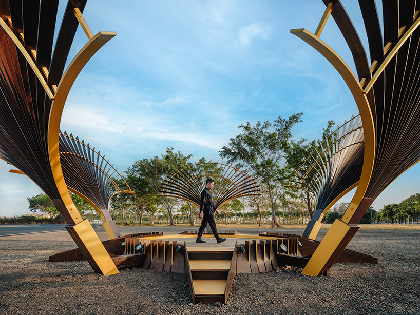 bent wooden beams fan like illuminating petals in cheng tsung feng&rsquo;s installation in taiwan