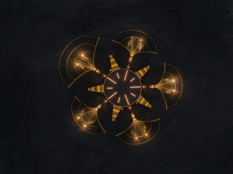 bent wooden beams fan like illuminating petals in cheng tsung feng&rsquo;s installation in taiwan