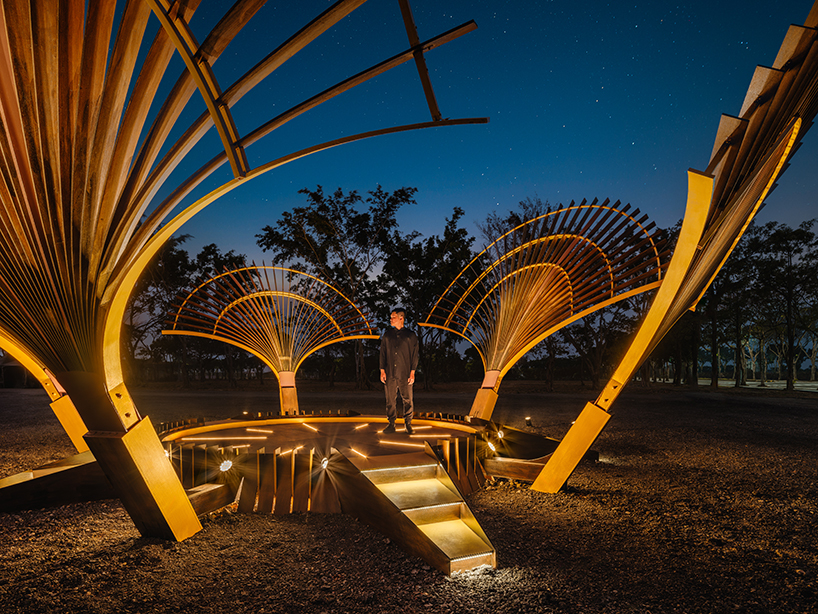 bent wooden beams fan like illuminating petals in cheng tsung feng&rsquo;s installation in taiwan
