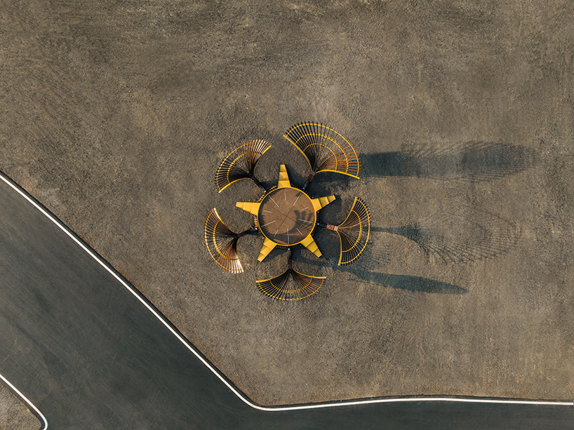 bent wooden beams fan like illuminating petals in cheng tsung feng&rsquo;s installation in taiwan