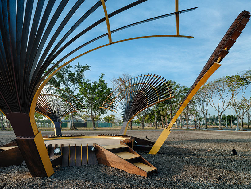 bent wooden beams fan like illuminating petals in cheng tsung feng&rsquo;s installation in taiwan