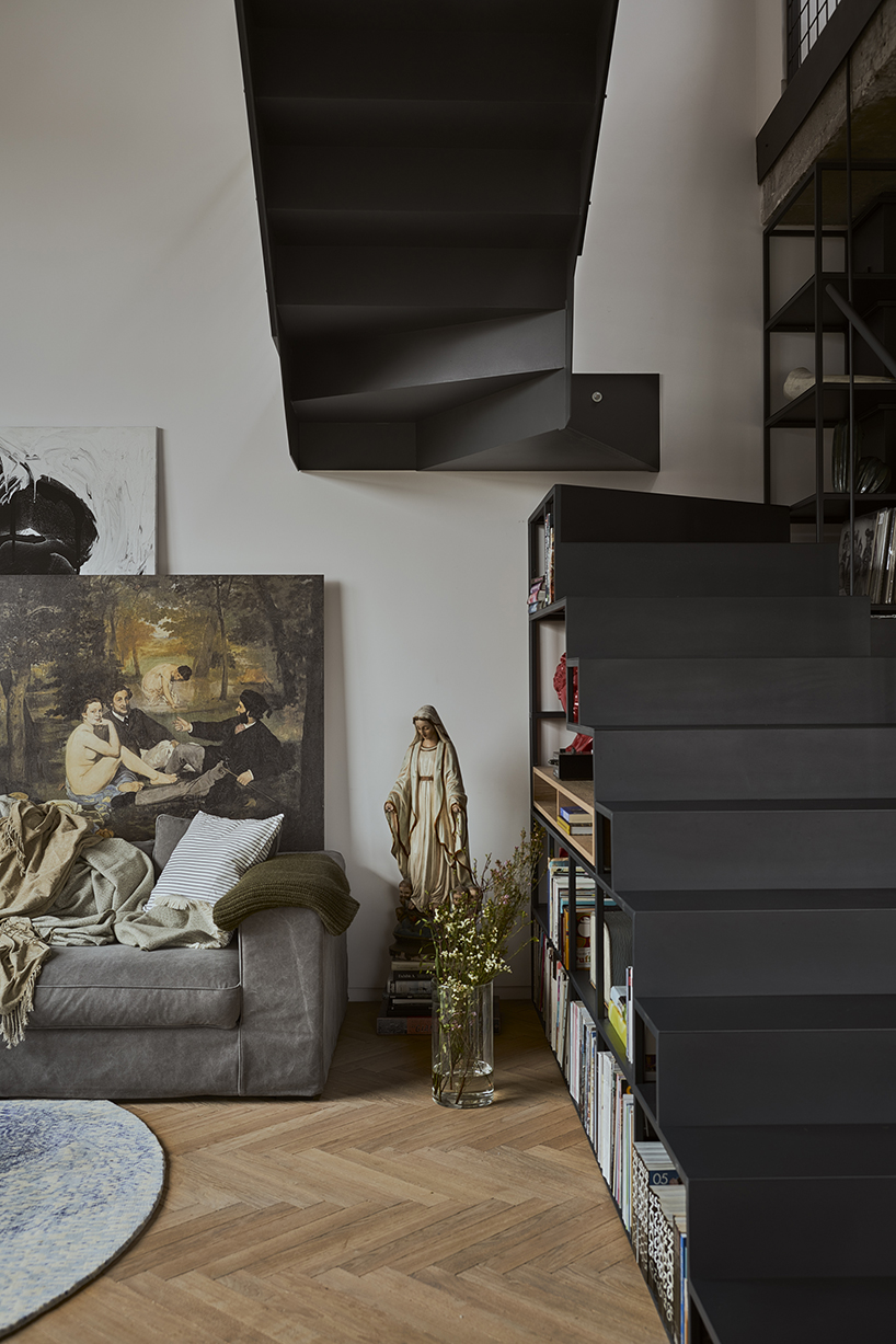 a steel staircase doubles as storage in this poznan apartment, designed by UGO designboom