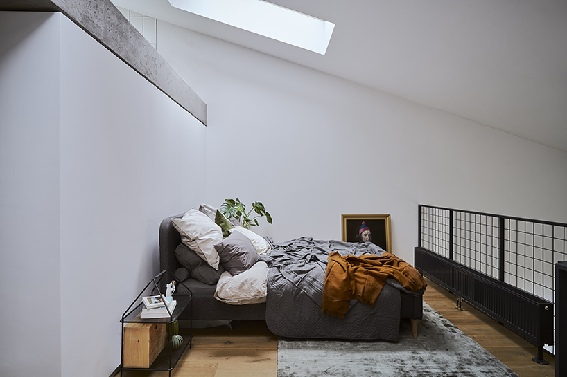 a steel staircase doubles as storage in this poznan apartment, designed by UGO designboom