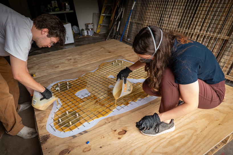 algae-based bio-resin puddle pavilion by i/thee hovers above mud creek in iowa