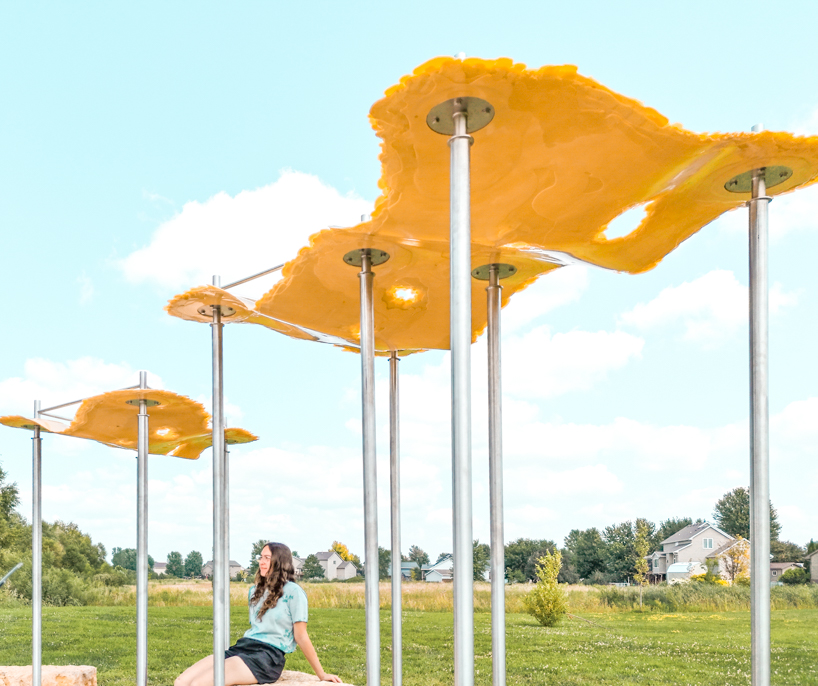 algae-based bio-resin puddle pavilion by i/thee hovers above mud creek in iowa