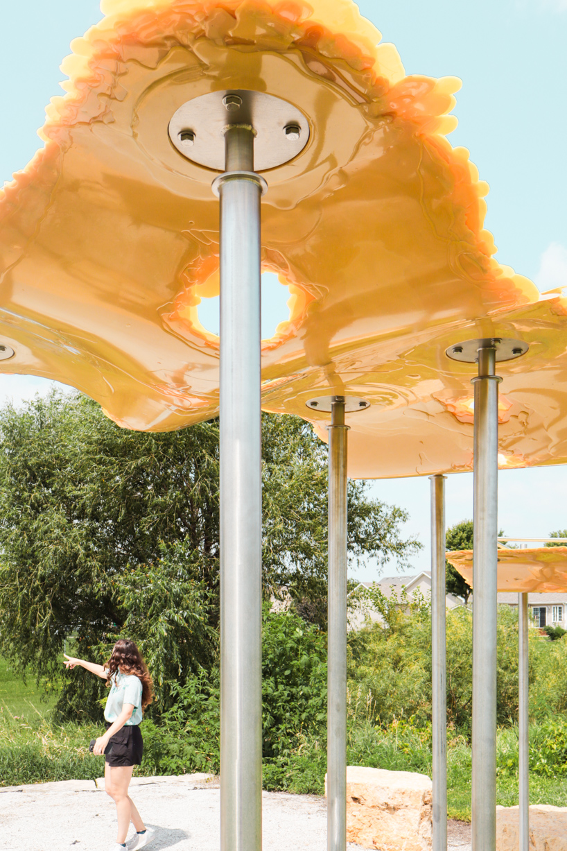 algae-based bio-resin puddle pavilion by i/thee hovers above mud creek in iowa