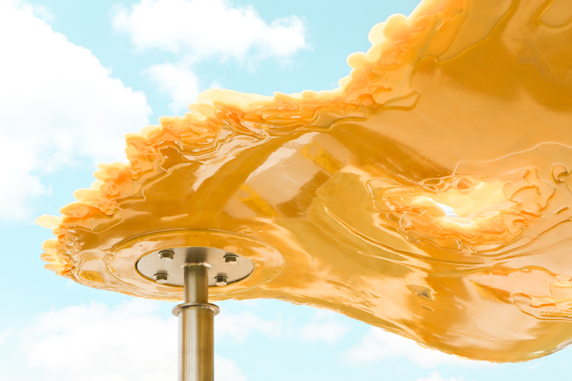 algae-based bio-resin puddle pavilion by i/thee hovers above mud creek in iowa