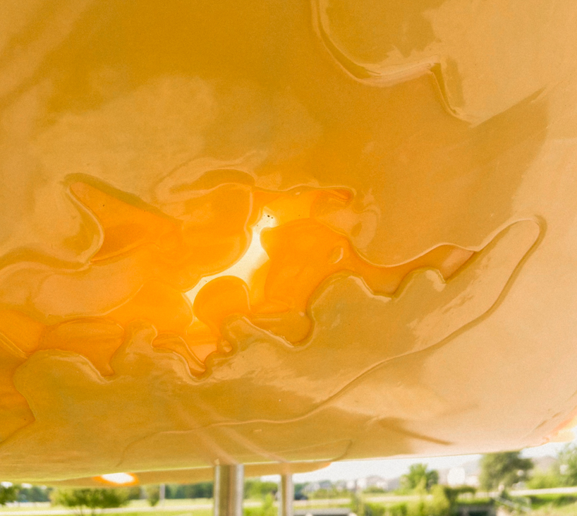 algae-based bio-resin puddle pavilion by i/thee hovers above mud creek in iowa