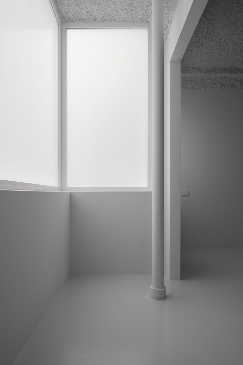 hanghar negates architecture in bare, abstract house responding to social standards