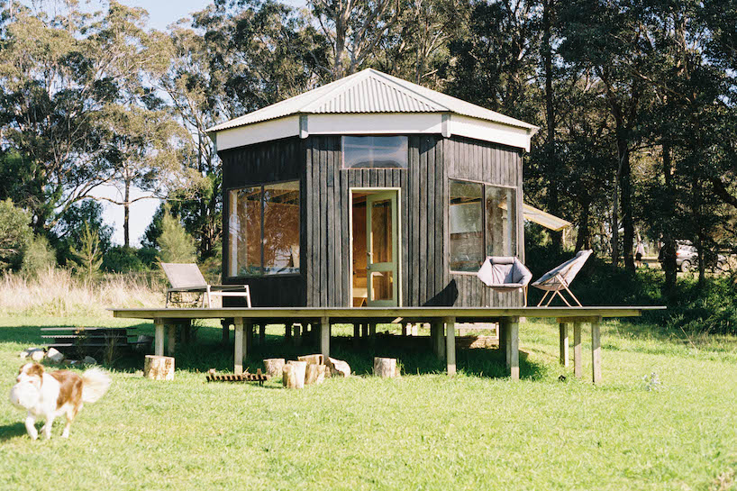 trouthouse revitalizes derelict museum as charred wood cabin in east gippsland, australia