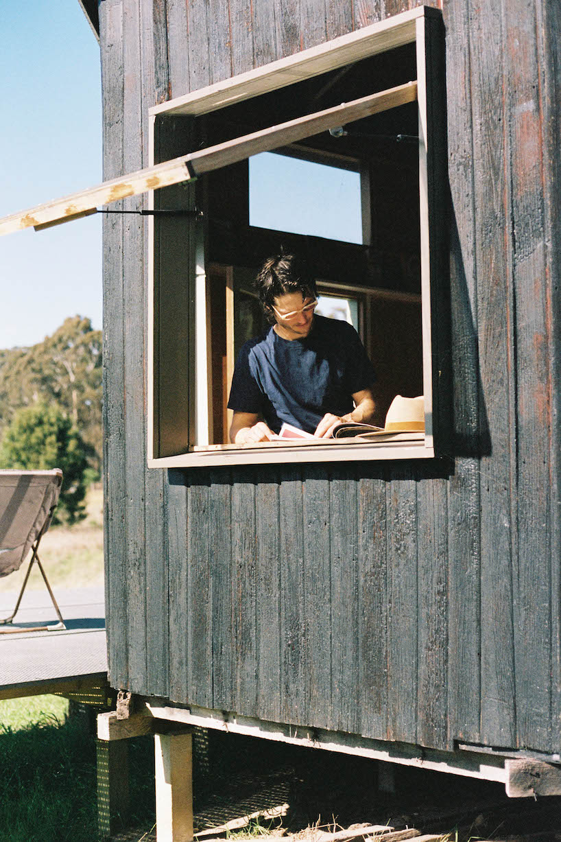 trouthouse revitalizes derelict museum as charred wood cabin in east gippsland, australia