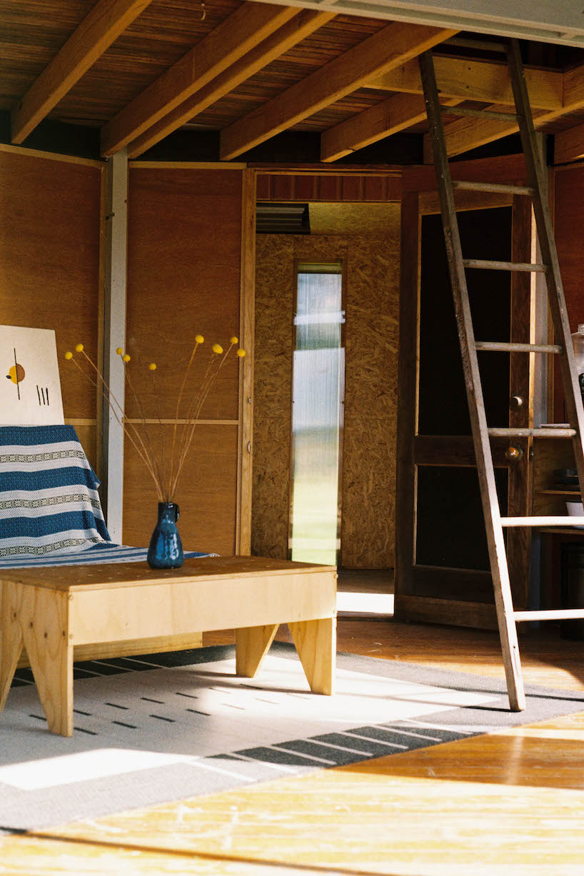 trouthouse revitalizes derelict museum as charred wood cabin in east gippsland, australia