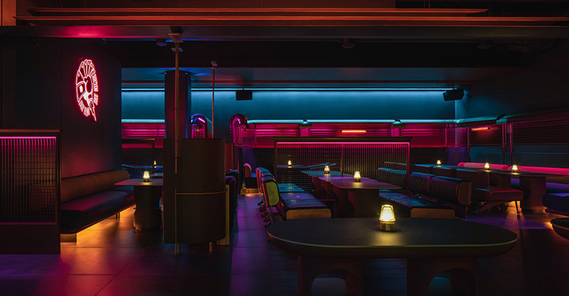 geometrical lines and pops of color create a tipsy night within retro pub in china