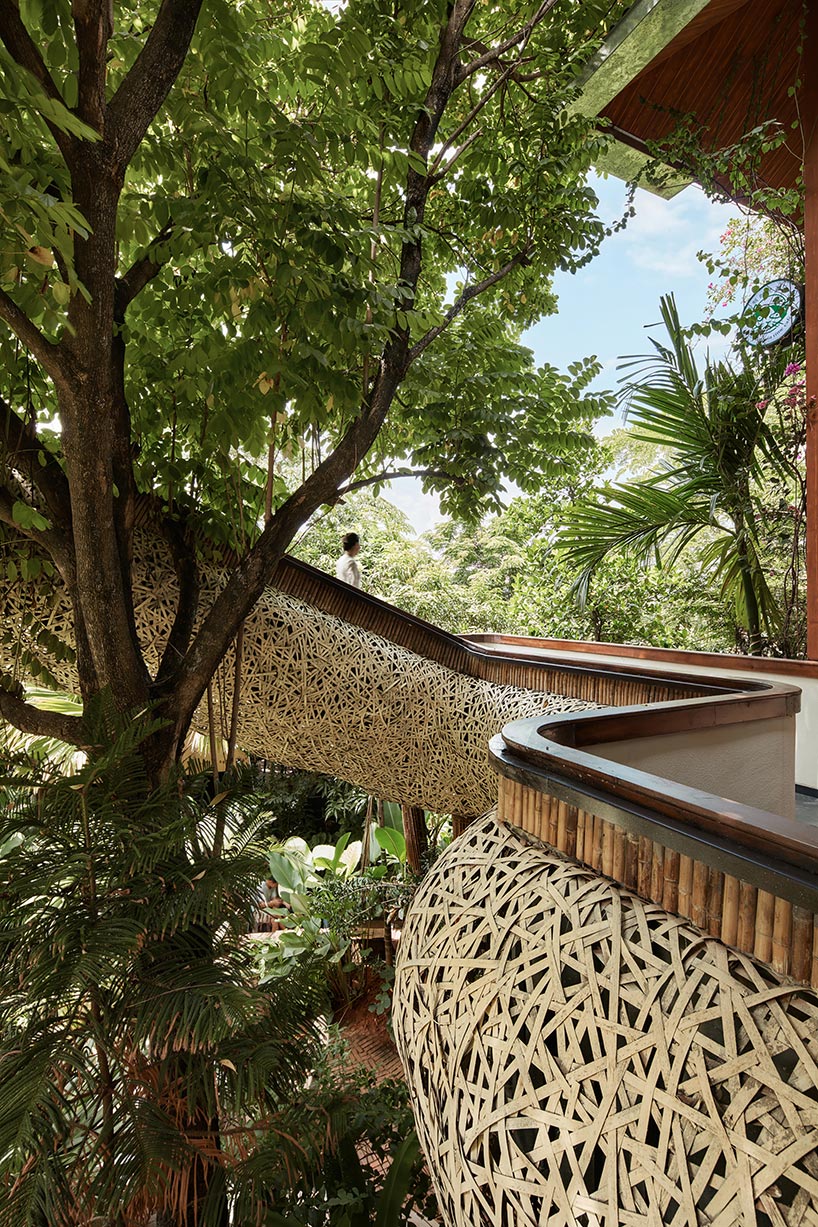 weaved bamboo wraps the floating promenades of spa and restaurant in china