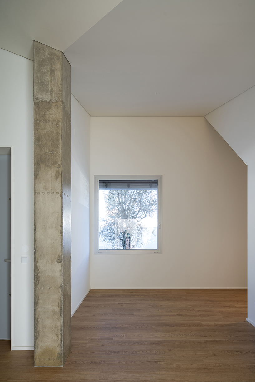 sculptural chimney pierces L-shaped house by martins architecture office in portugal