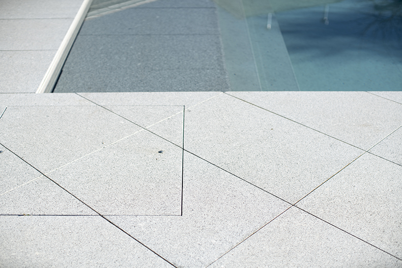 sculptural chimney pierces L-shaped house by martins architecture office in portugal