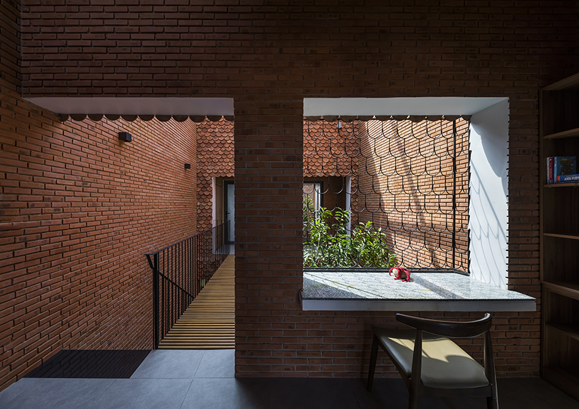 red brick and fish-scale tiles clad this family house by CTA in vietnam