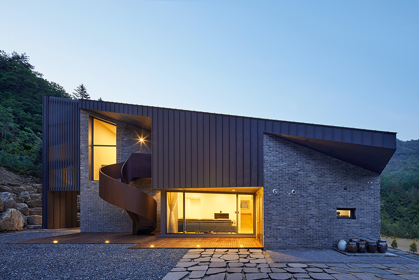 slope house by studio eon creates a roof that becomes a facade of the house 2