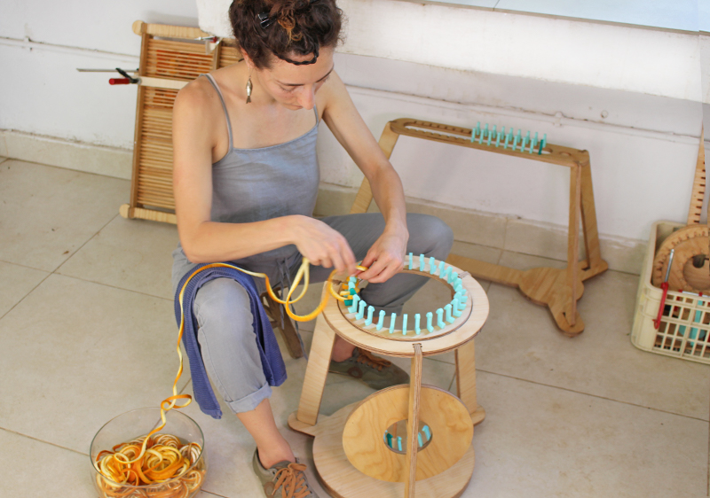 yuli meroz cuts, folds and knits orange peels to create intricate crafts
