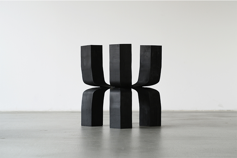 takuto ohta slices into japanese cedar to create sculptural tension for asymptotic wood series