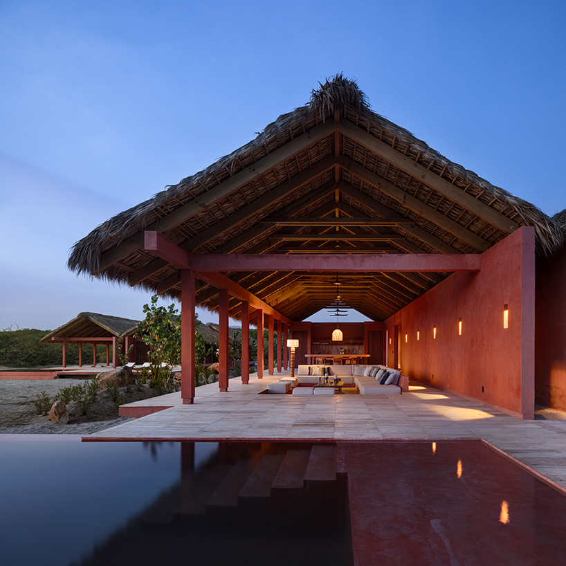 palm fronds top bloqe arquitectura's cluster of traditional houses along oaxaca coastline