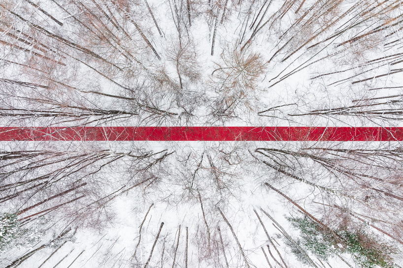 gregory orekhov rolls out 250-meter-long red carpet across snowy russian landscape