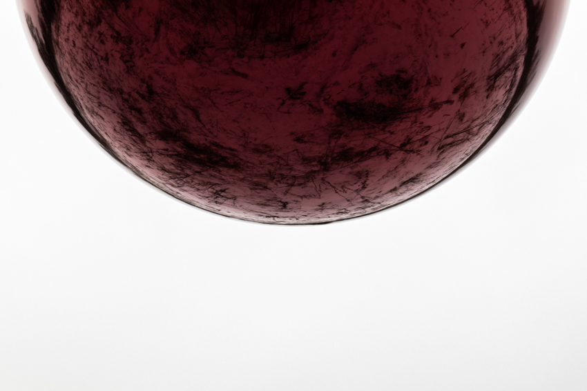 reflective red sphere suspends from tree in gregory orekhov&rsquo;s land art installation