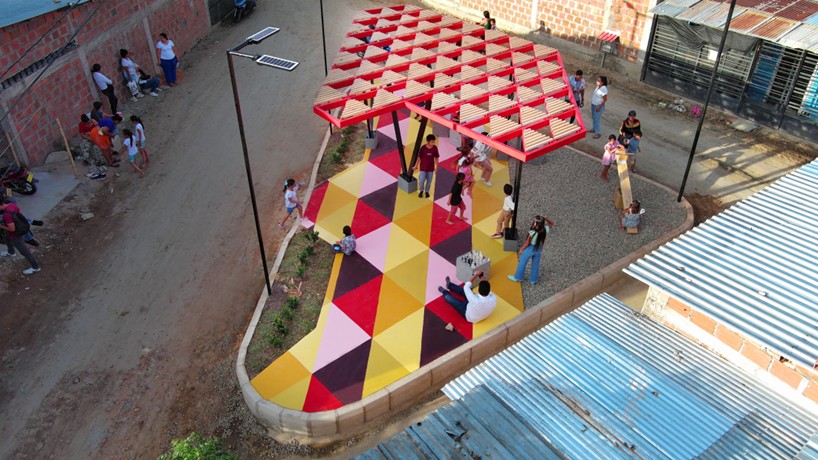 recycled materials transform abandoned triangular lot in colombia into colorful urban space